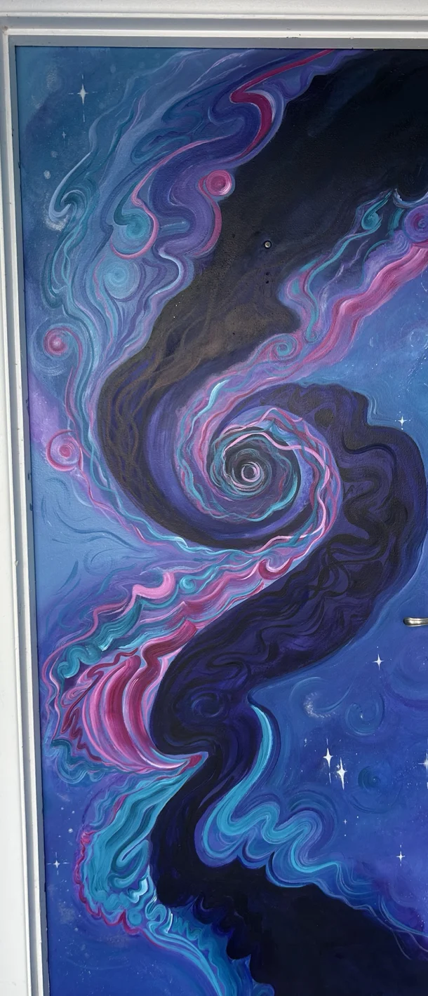A front door painted as deep space. A violet and magenta nebula spiralling around a central swirl, scattered with stars.