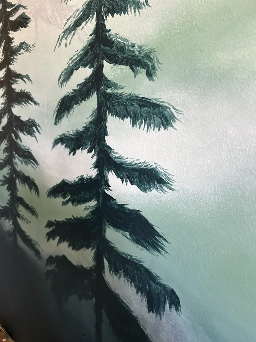 A close detail of the feathered brushwork on a single misty fir.